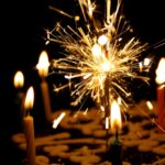 A close-up of brightly lit birthday candles, illustrating festive and celebratory birthday party ideas in Charlotte NC. The vibrant flames and colorful candles add to the joyful ambiance, perfect for creating memorable birthday celebrations.