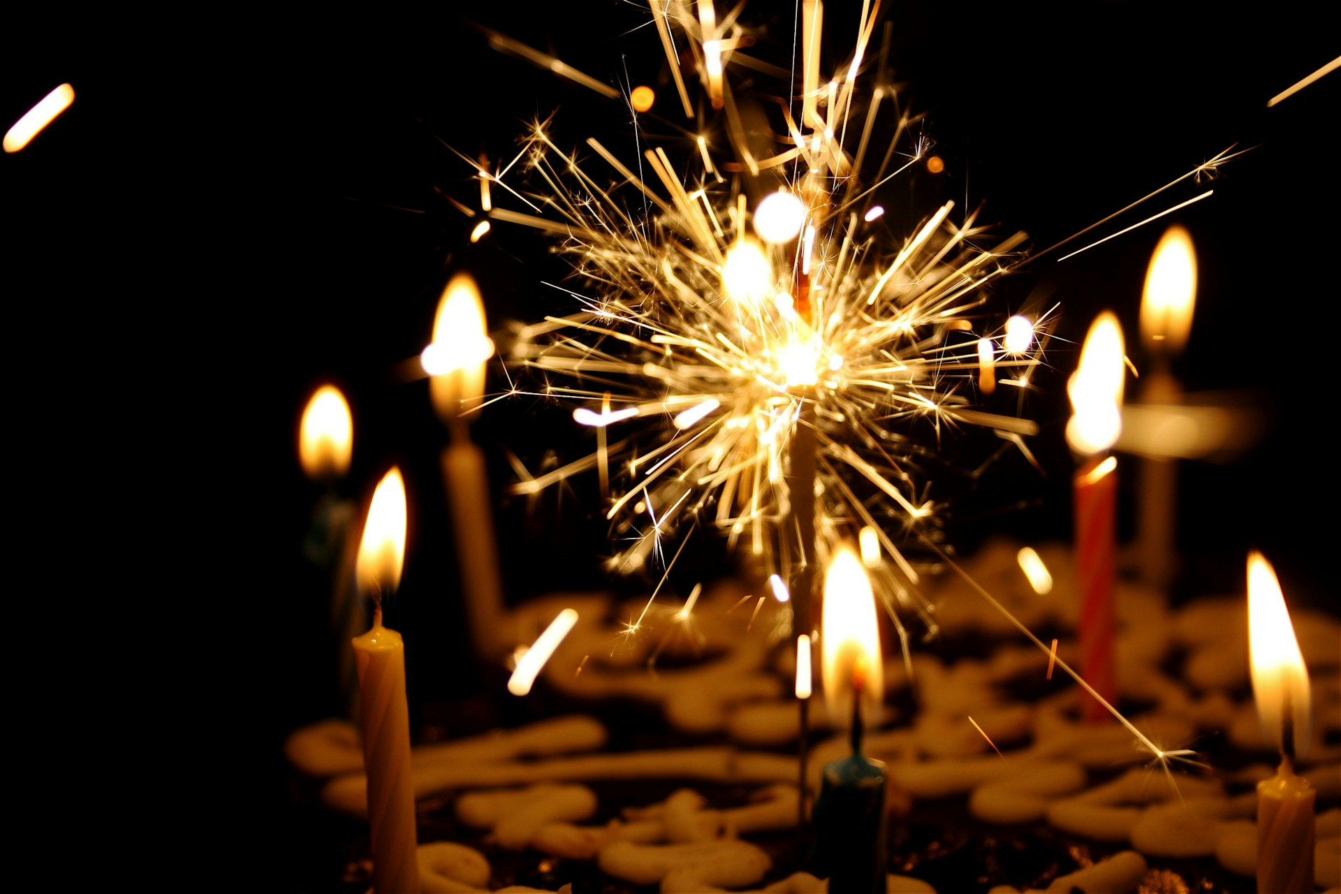 A close-up of brightly lit birthday candles, illustrating festive and celebratory birthday party ideas in Charlotte NC. The vibrant flames and colorful candles add to the joyful ambiance, perfect for creating memorable birthday celebrations.